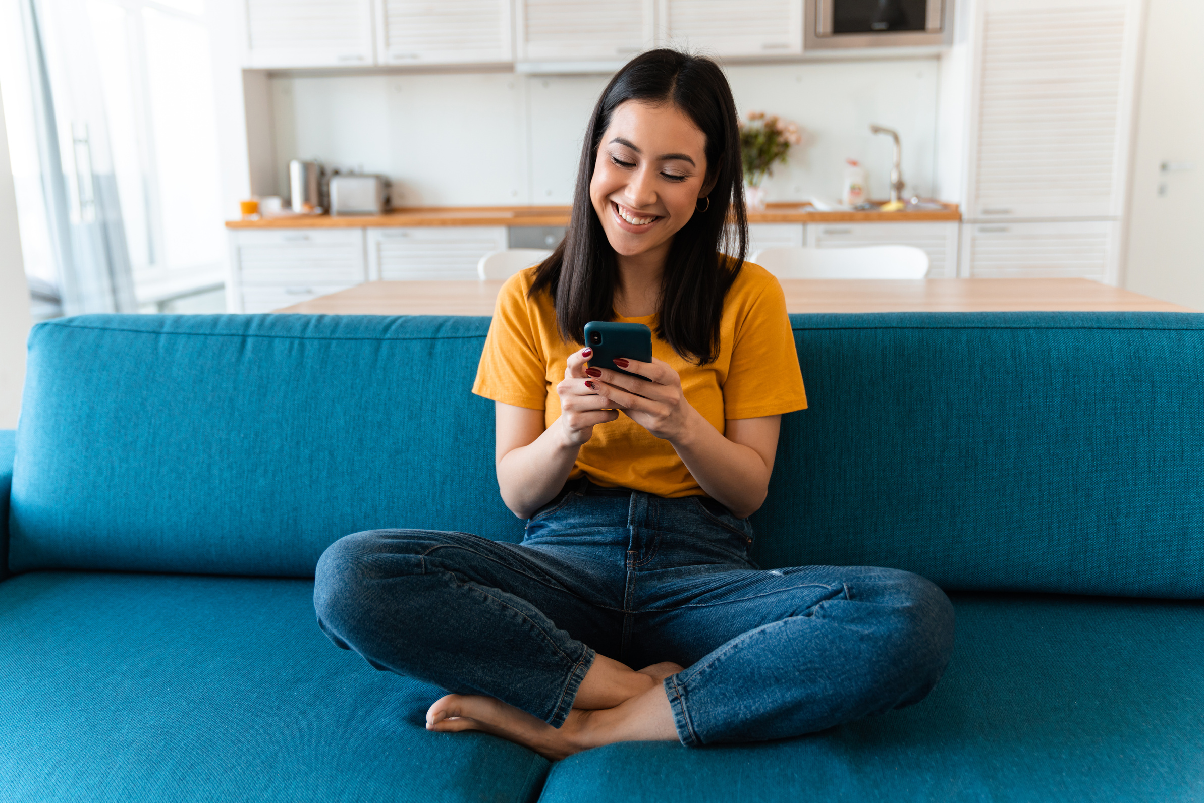 Woman Sitting on the Sofa Using Smartphone 